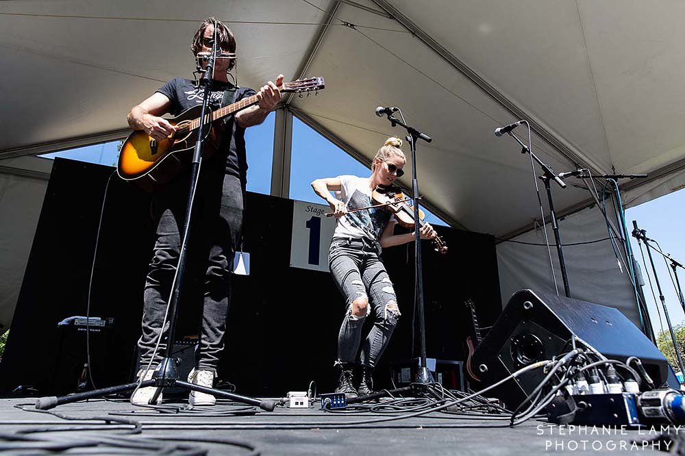 Canadian singer songwriter Dustin Bentall and Canadian singer/musician and fiddler Kendel Carson on stage 1 during Day 2 of the Vancouver Folk Music Festival at Jericho beach park on Saturday Jul 14, 2018, in Vancouver, BC, Canada - Photo © Stephanie Lamy