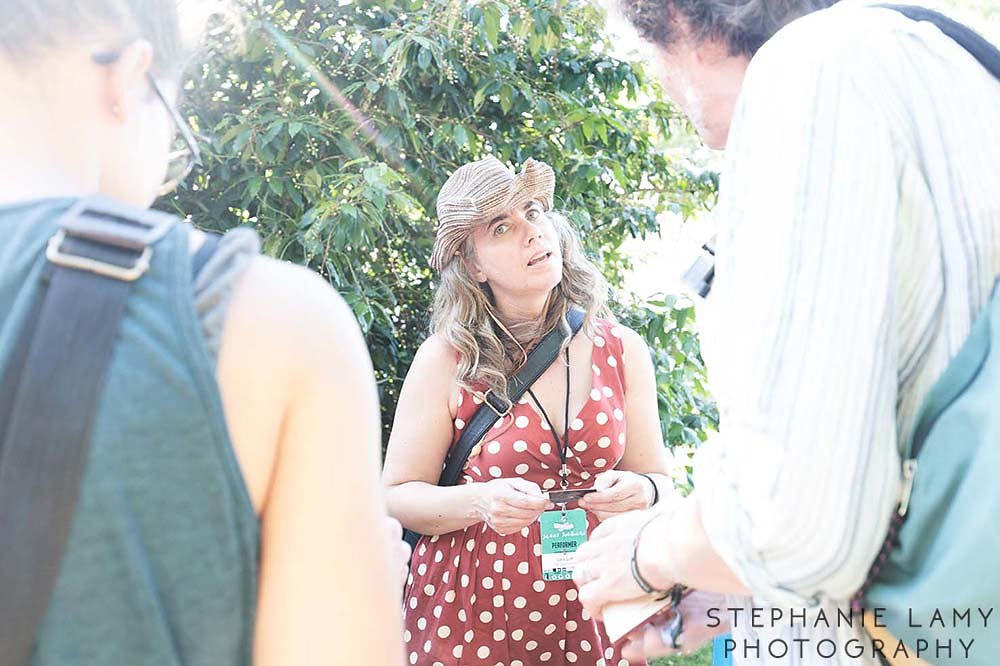 Cara Luft (guitar/banjo/vocals) and JD Edwards (guitar/harmonica/vocals) at the CD tent signing some cds during Day 2 of the Vancouver Folk Music Festival at Jericho beach park on Saturday Jul 14, 2018, in Vancouver, BC, Canada - Photo © Stephanie Lamy